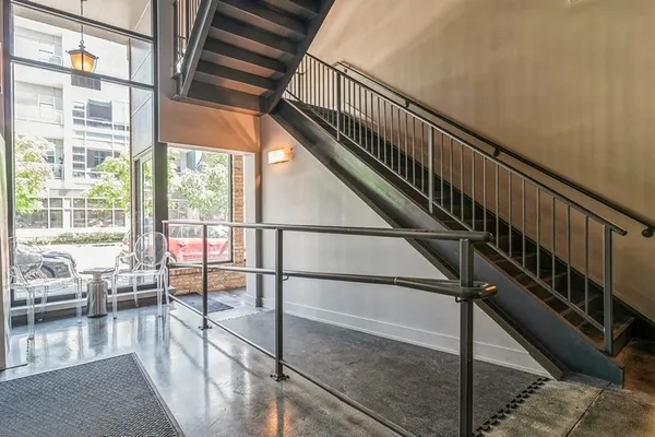 a lobby with furniture and view of kitchen
