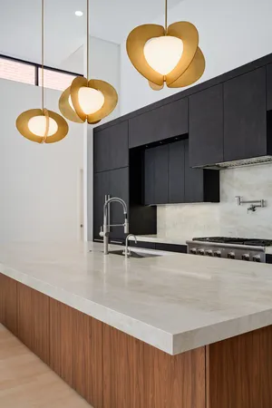 a kitchen with a sink a stove and cabinets
