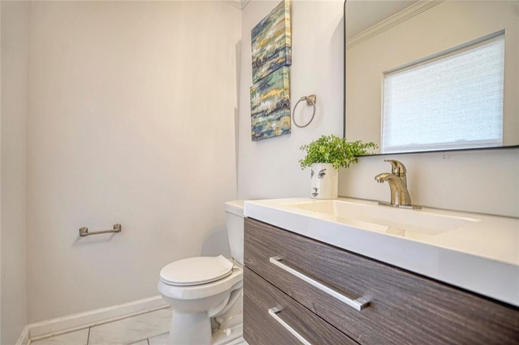 2230 Beecher Circle Southwest Atlanta, GA 30311 - Photo 19 of 29 a bathroom with a sink a toilet and mirror