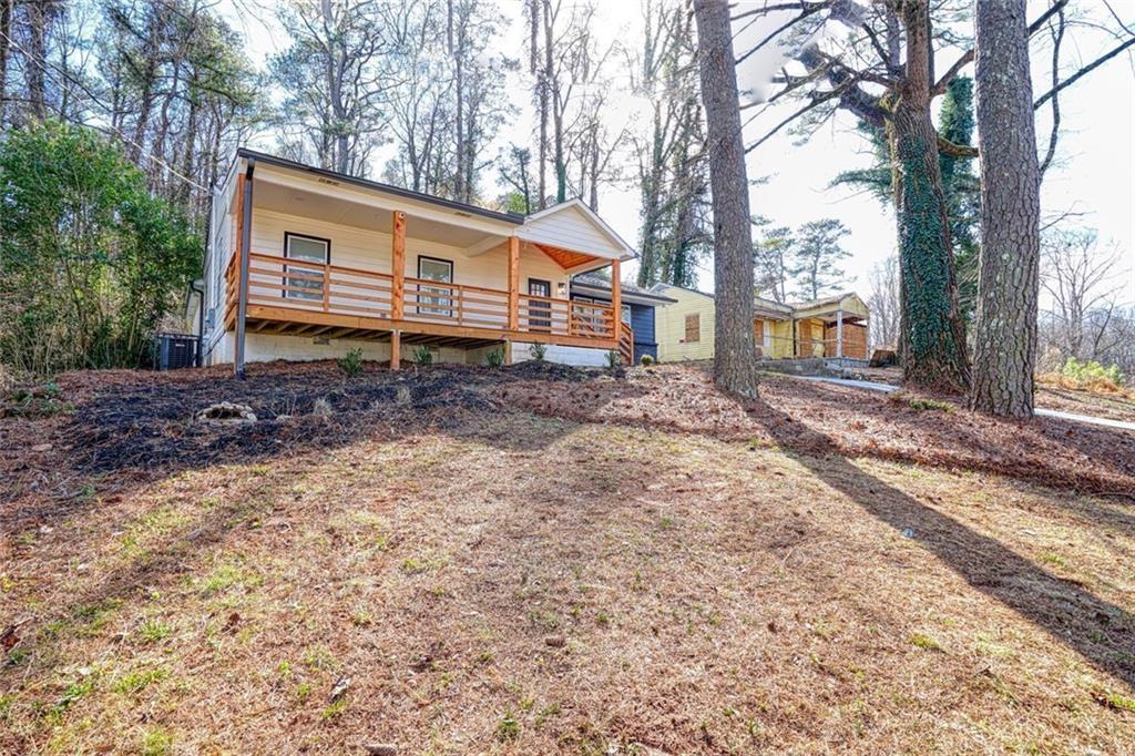2230 Beecher Circle Southwest Atlanta, GA 30311 - Photo 28 of 29 a front view of a house with a yard and balcony