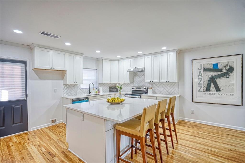 2230 Beecher Circle Southwest Atlanta, GA 30311 - Photo 6 of 29 a kitchen with a table chairs and a refrigerator