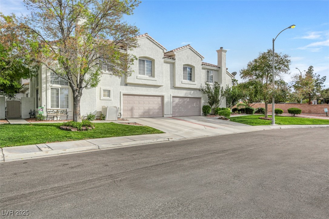 2907 Rio Sonora Court Henderson, NV 89074 - Photo 3 of 35 Mediterranean / spanish-style home featuring concrete driveway, a garage, stucco siding, a tile roof, and a chimney