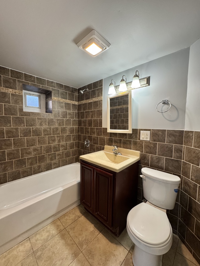 1263 North Springfield Avenue, Unit 1 Chicago, IL 60651 - Photo 9 of 9 a bathroom with a sink toilet and shower
