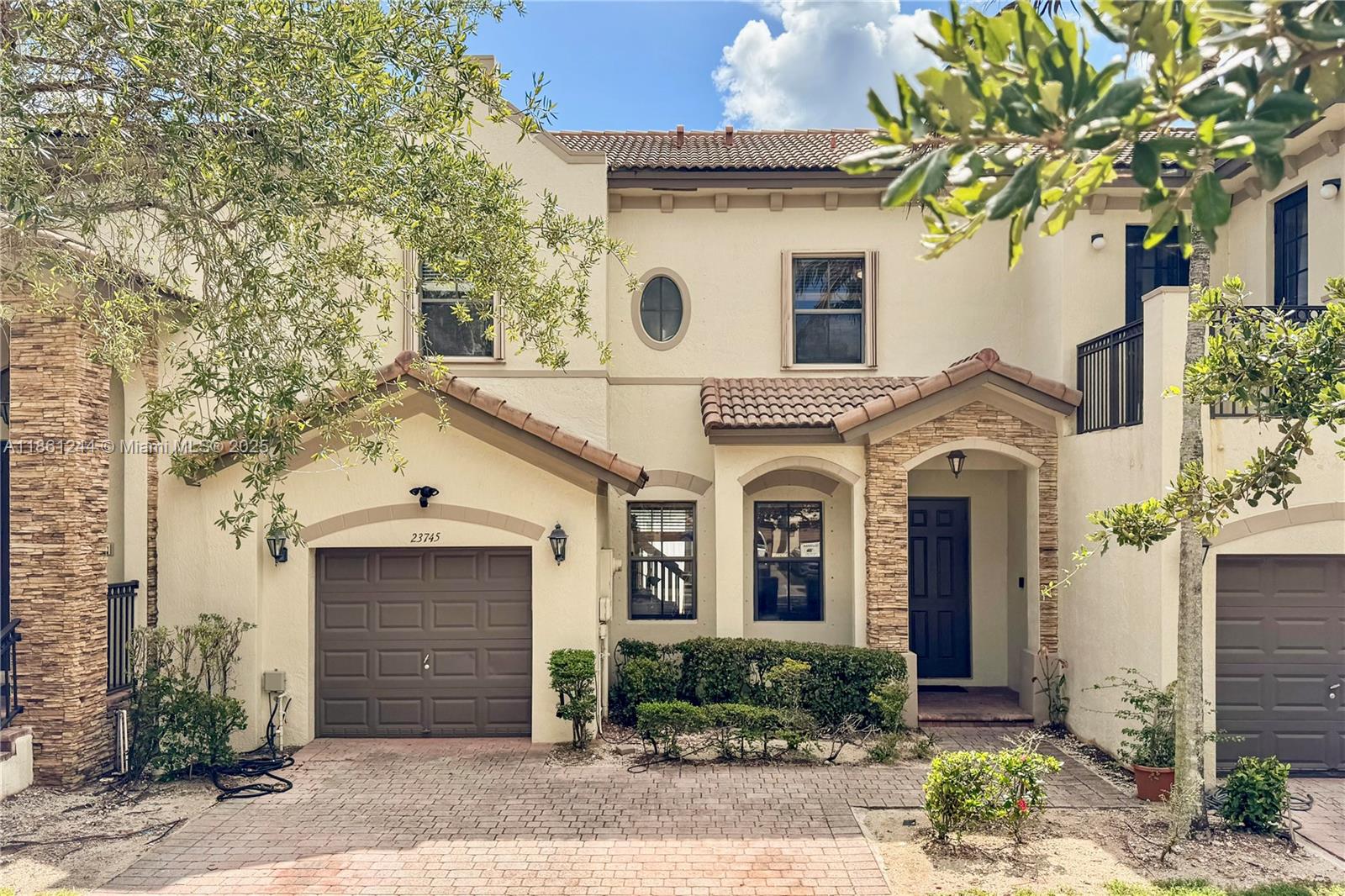 a front view of a house with garden