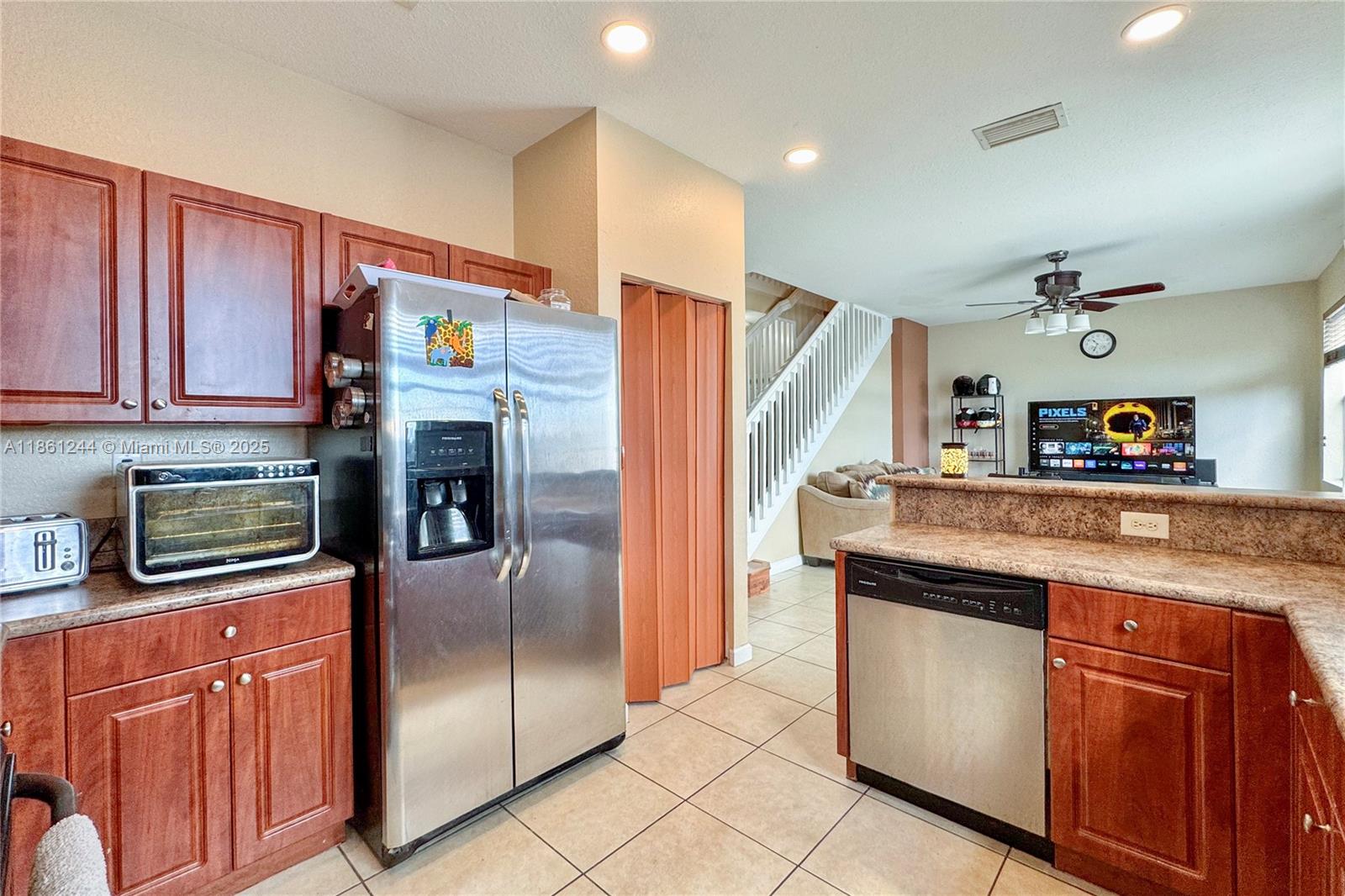23745 Southwest 114 Court Homestead, FL 33032 - Photo 11 of 30 a kitchen with stainless steel appliances granite countertop a refrigerator and a sink