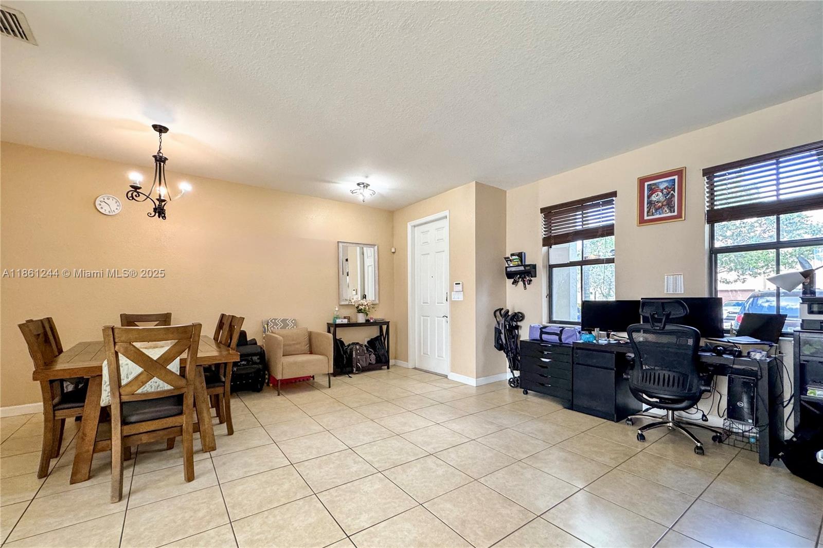 23745 Southwest 114 Court Homestead, FL 33032 - Photo 13 of 30 a view of a livingroom with workspace and a window