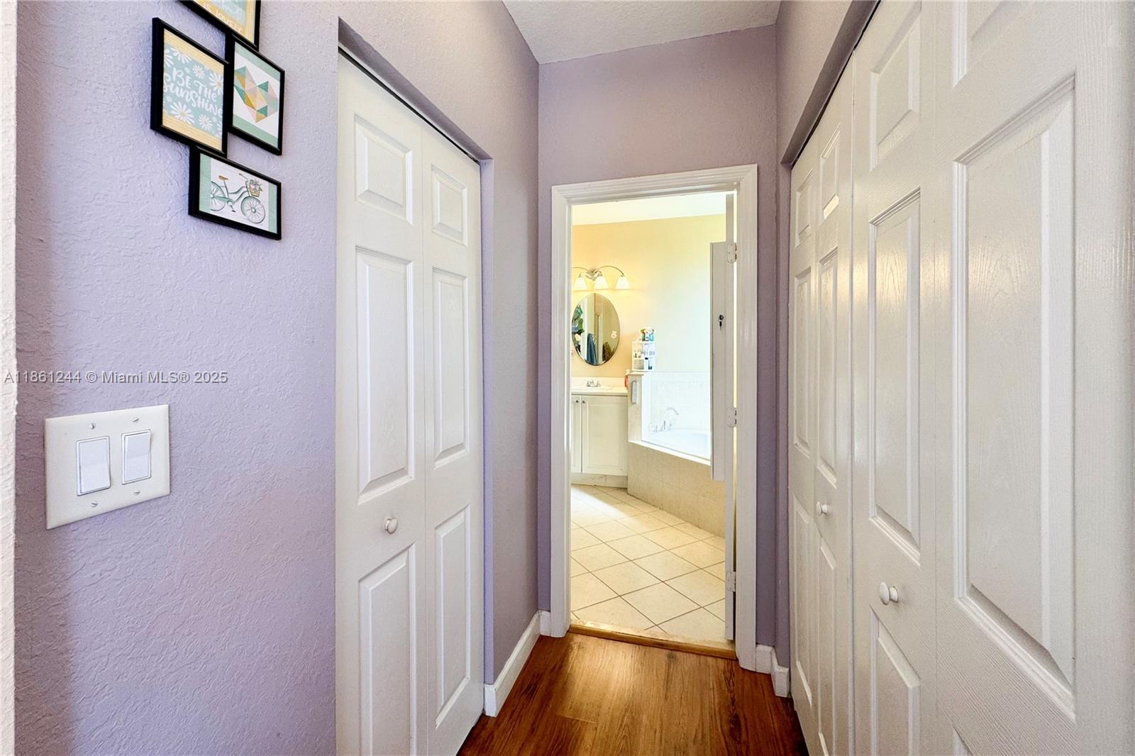 23745 Southwest 114 Court Homestead, FL 33032 - Photo 27 of 30 a view of a hallway with wooden floor and a bathroom