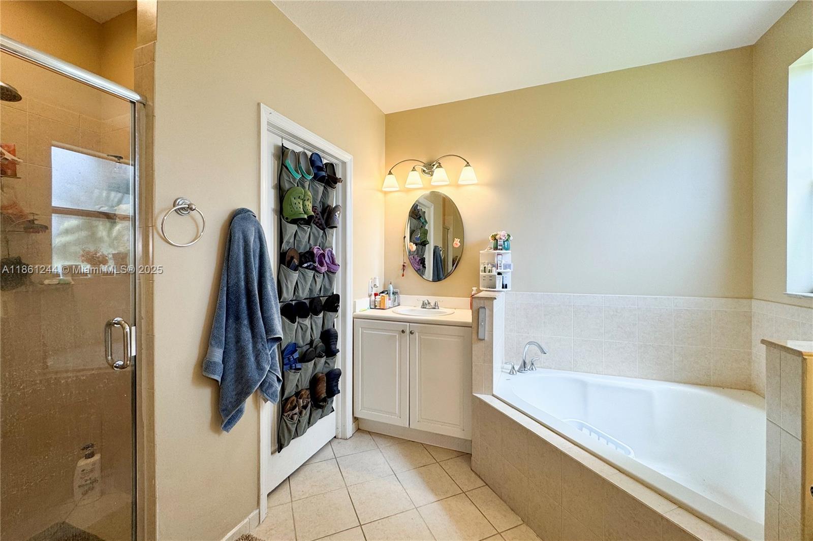 23745 Southwest 114 Court Homestead, FL 33032 - Photo 28 of 30 a bathroom with a tub sink and mirror