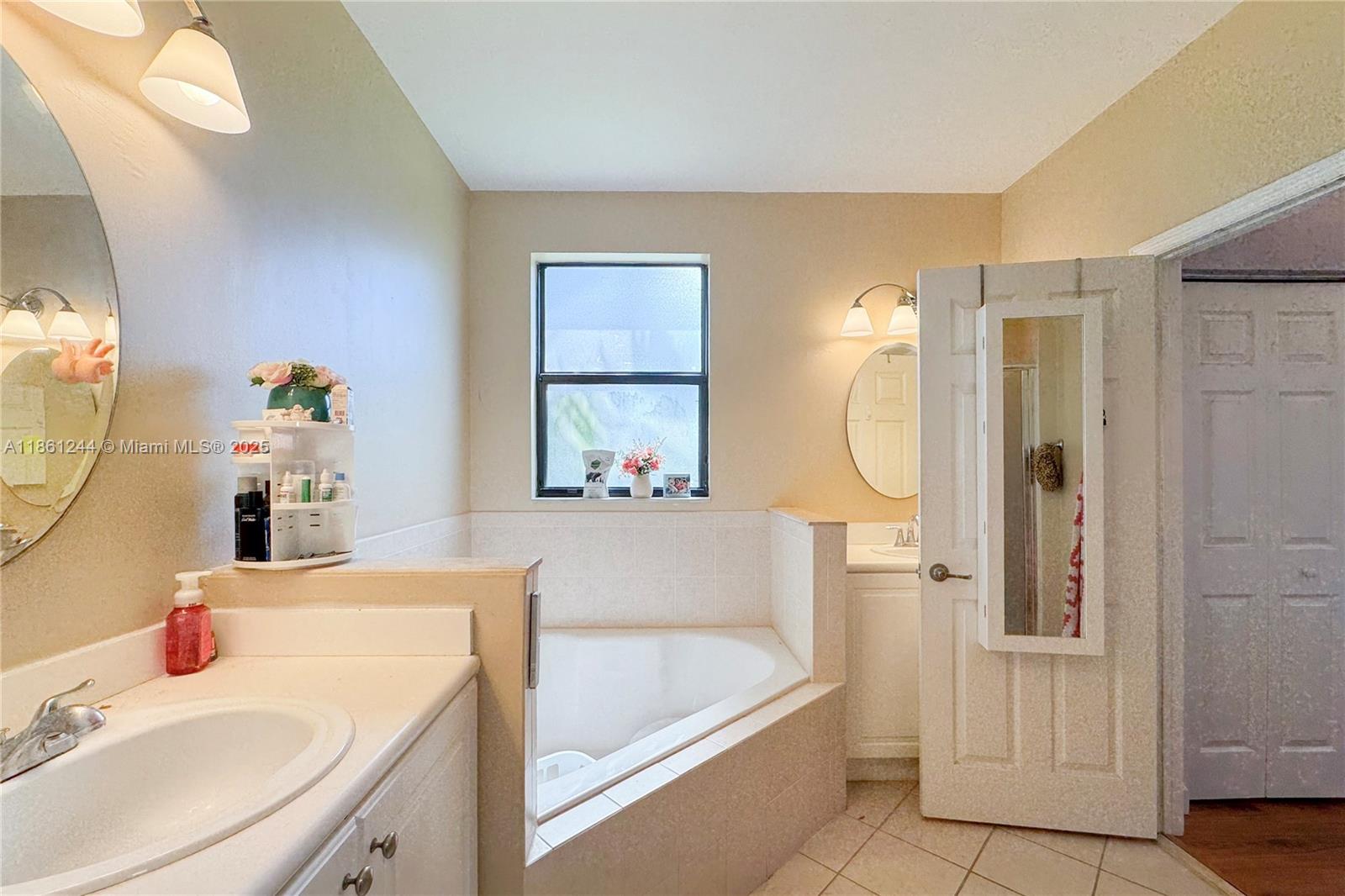 23745 Southwest 114 Court Homestead, FL 33032 - Photo 29 of 30 a bathroom with a tub sink and mirror