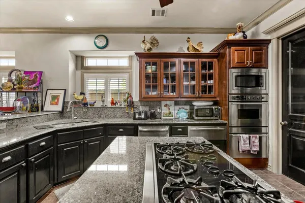 a kitchen with stainless steel appliances a stove and a sink