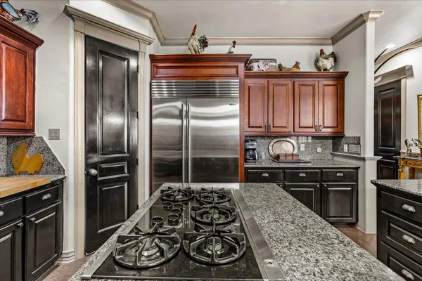 a kitchen with granite countertop stainless steel appliances and wooden cabinets