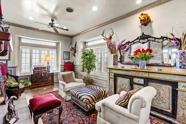 a living room with furniture a chandelier and a rug