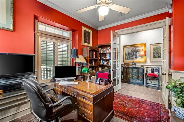 a living room with furniture a flat screen tv and a window
