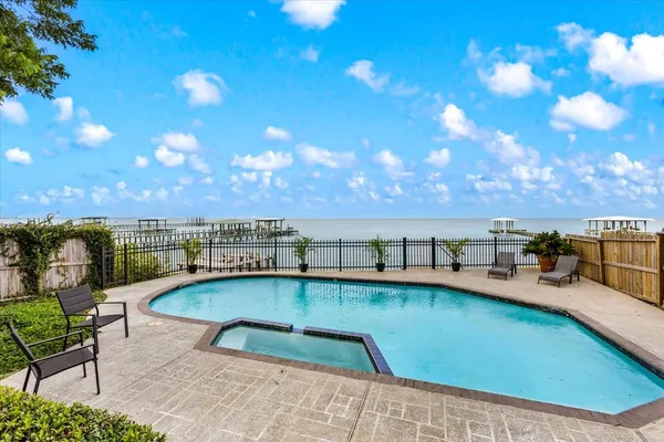 a view of a swimming pool with seating area