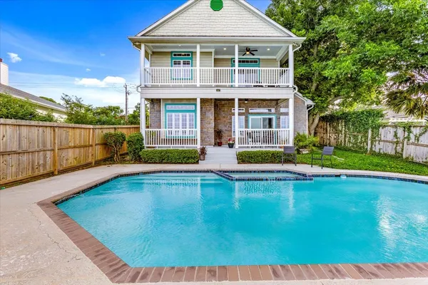 a view of a house with swimming pool and sitting area