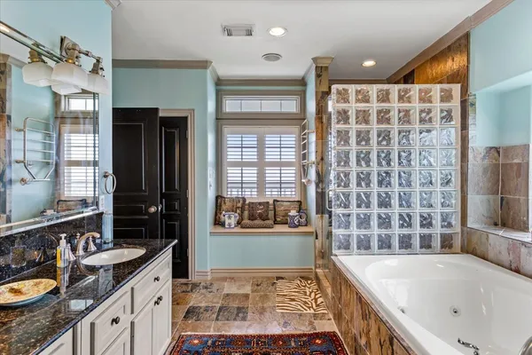 a bathroom with a tub sink and mirror