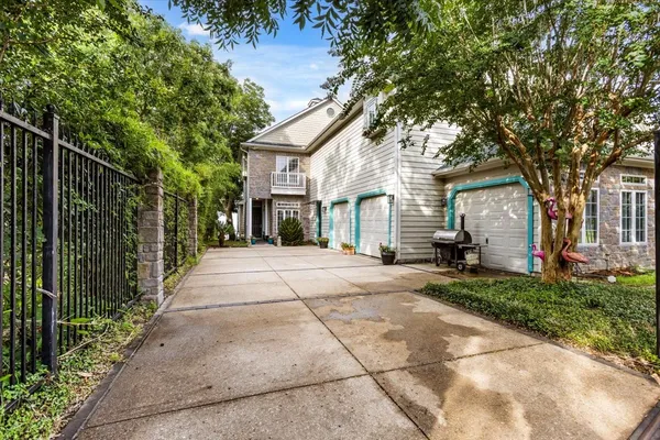 a front view of a house with a yard and potted plants