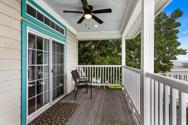 a view of a balcony with floor to ceiling windows and wooden floor