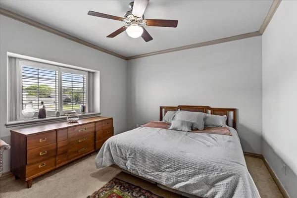 a bedroom with a large bed and a large window