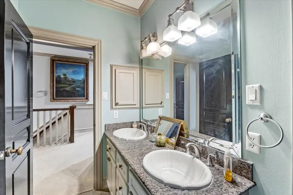 a bathroom with a granite countertop sink mirror and vanity