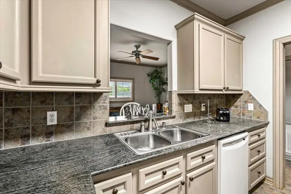 a kitchen with stainless steel appliances granite countertop a sink stove and cabinets