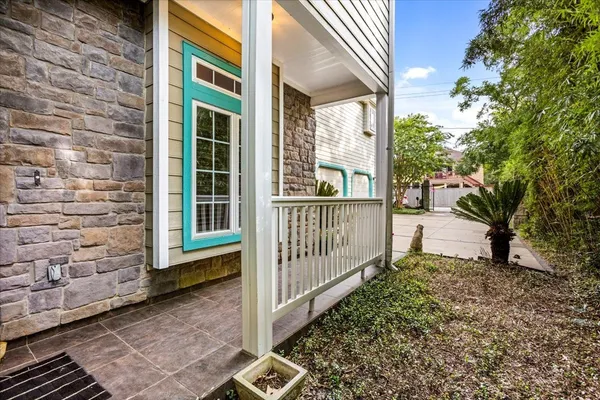 a view of a house with a large window and wooden fence