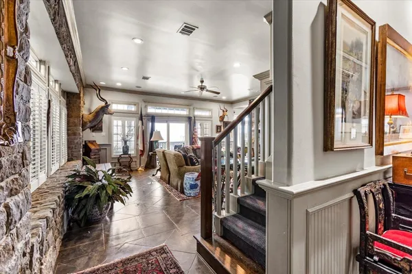a view of entryway and hall with wooden floor