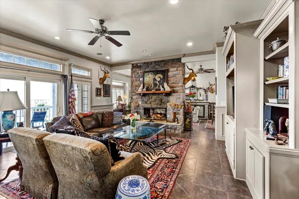a living room with furniture kitchen view and a large window