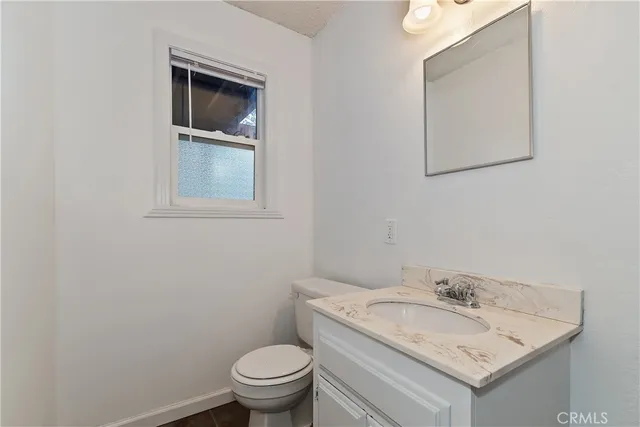 a bathroom with a toilet sink and a mirror