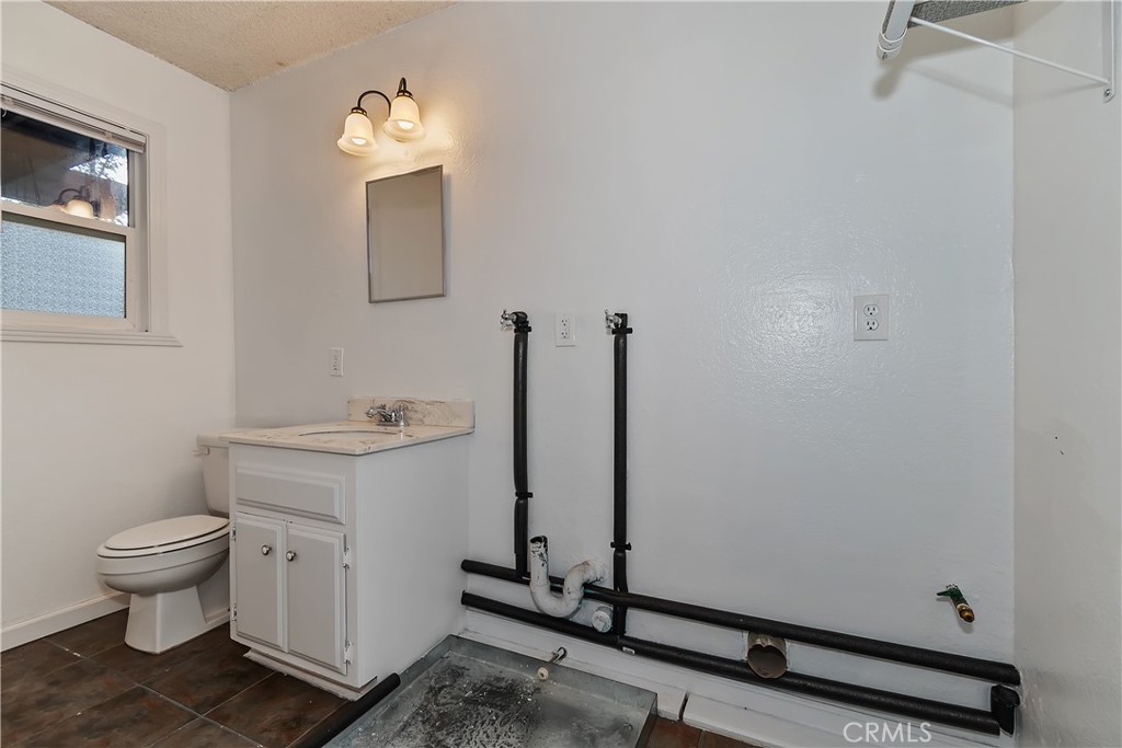 245 Vista Sugarloaf, CA 92386 - Photo 33 of 50 a bathroom with a toilet sink and a mirror