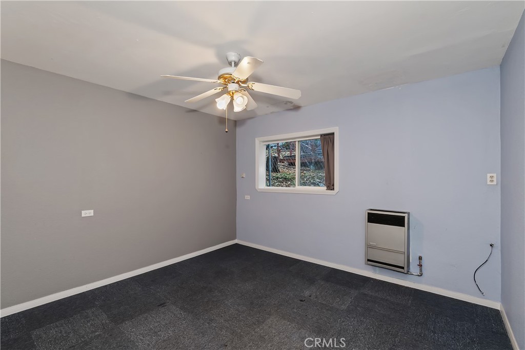 245 Vista Sugarloaf, CA 92386 - Photo 10 of 50 an empty room with windows and fan
