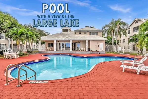 a view of swimming pool with a lounge chairs