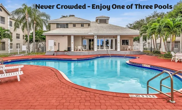 a view of swimming pool with outdoor seating and house in the background