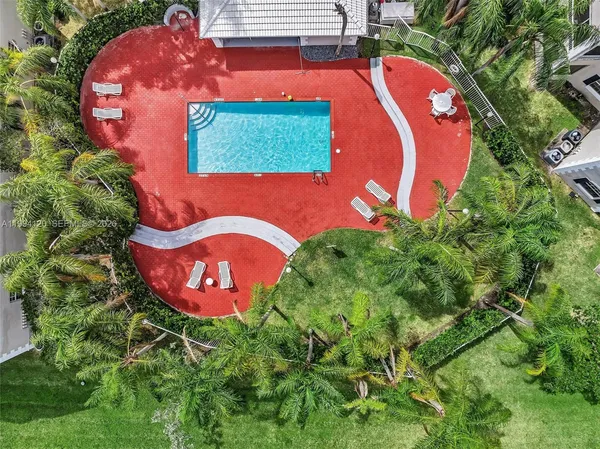 an aerial view of a house with a swimming pool and outdoor space
