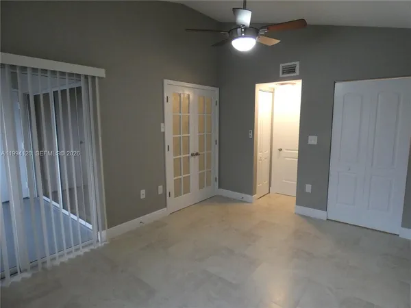 an empty room with closet area