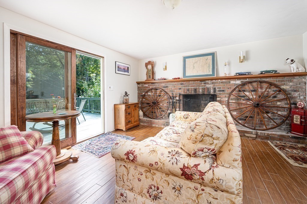 215 Stafford Road Holland, MA 01521 - Photo 20 of 36 a bedroom with a bed and a table with wooden floor