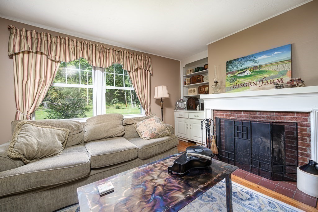 215 Stafford Road Holland, MA 01521 - Photo 23 of 36 a living room with furniture and a fireplace