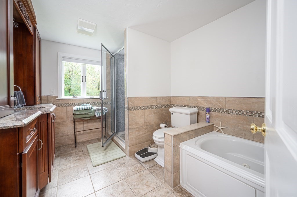 215 Stafford Road Holland, MA 01521 - Photo 32 of 36 a bathroom with a sink a toilet and tub
