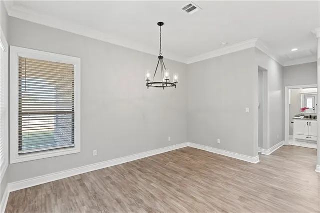 a kitchen with stainless steel appliances kitchen island granite countertop a dining table and chairs