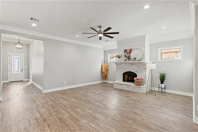 a view of a livingroom with a fireplace and a chandelier