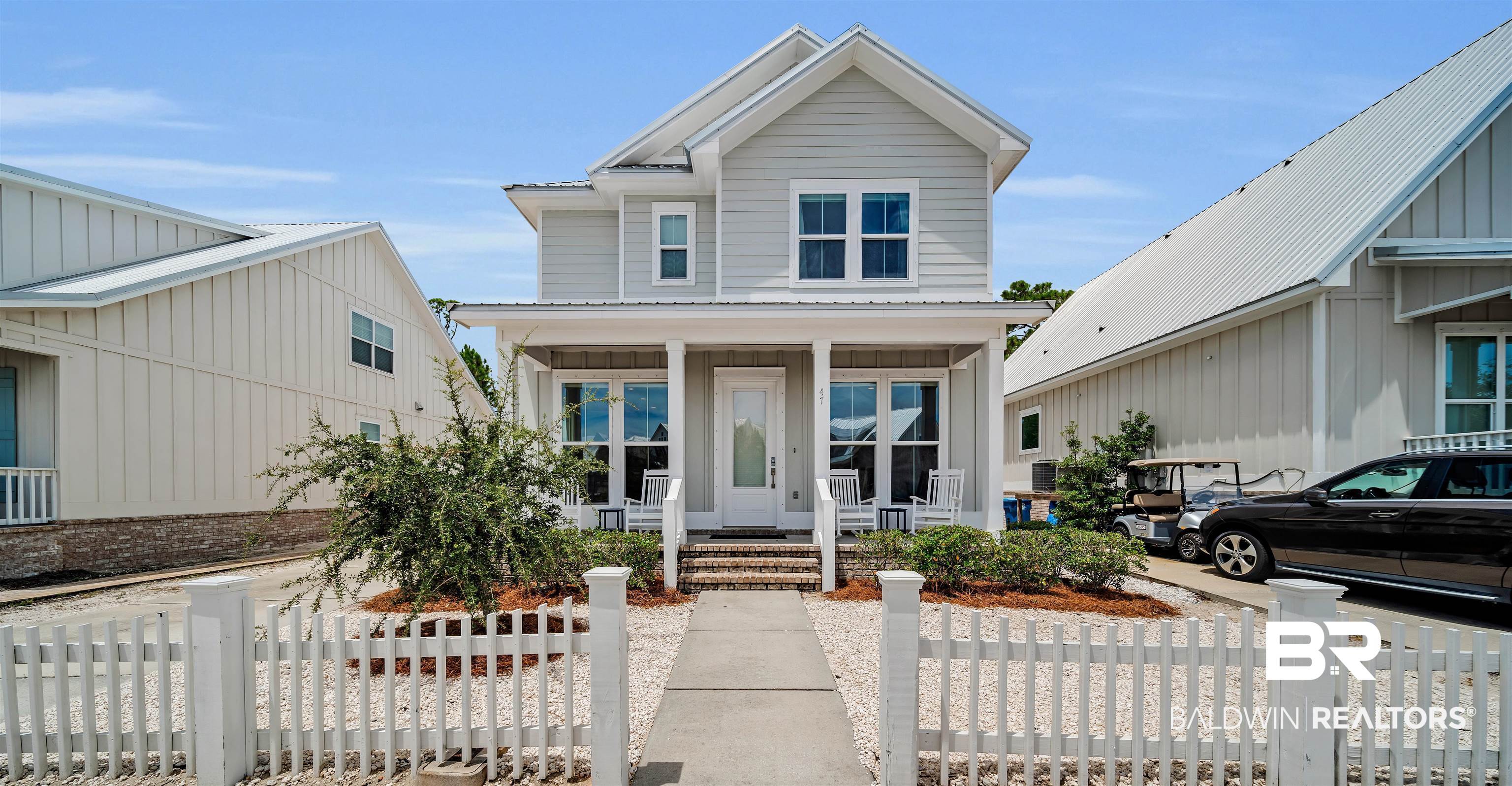 47 Parks Edge Orange Beach, AL 36561 - Photo 1 of 40 View of front of home featuring covered porch, a fenced front yard, and board and batten siding