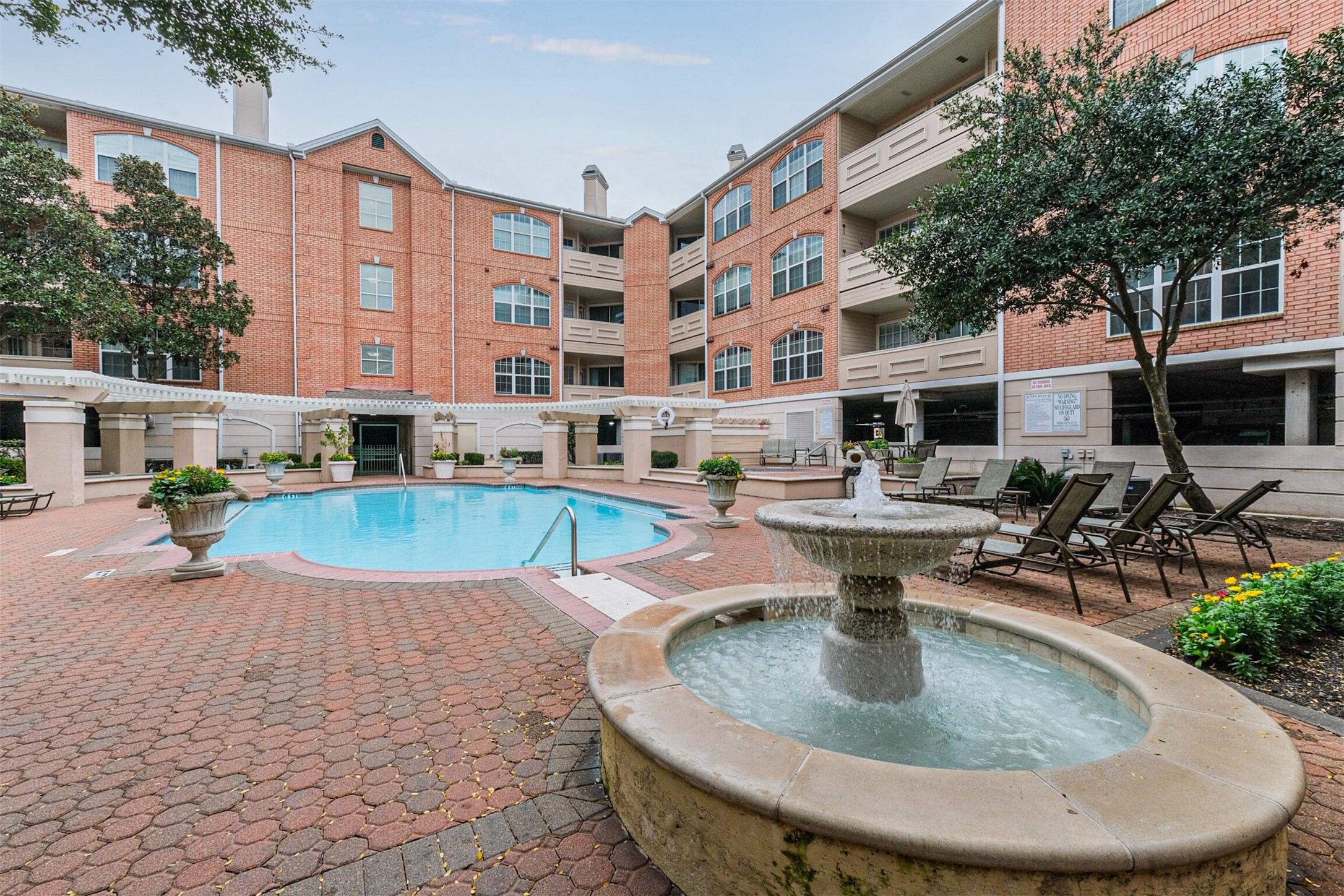 2111 Welch Street, Unit B304 Houston, TX 77019 - Photo 30 of 37 a view of a swimming pool with outdoor seating