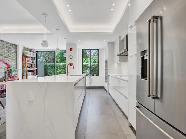 a kitchen with stainless steel appliances a refrigerator sink and microwave
