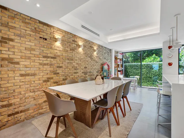 a dining room with a wooden table and chairs