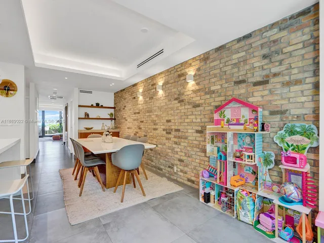 a view of a dining room and a table chairs in a room