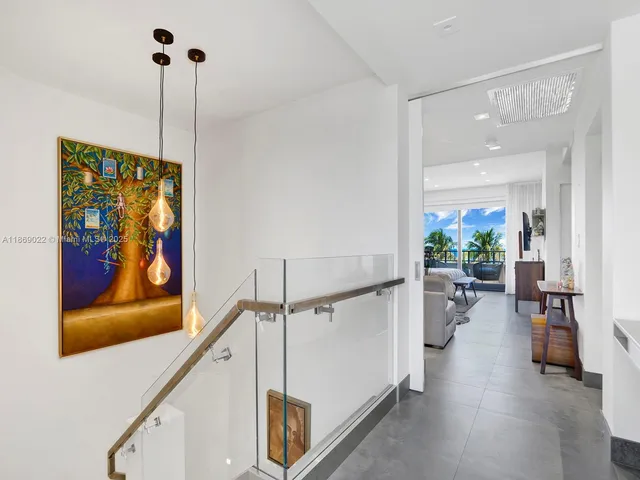 a bedroom with furniture and a large window