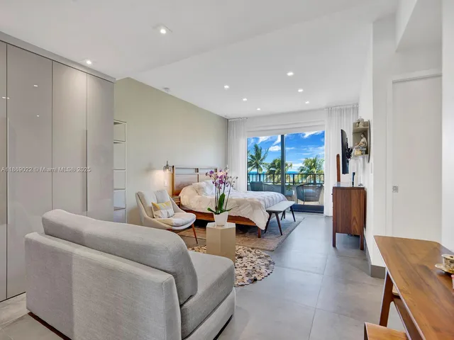 a living room with furniture and a floor to ceiling window