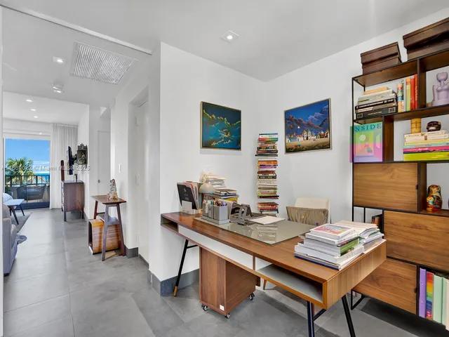 a dining room with furniture and a potted plant
