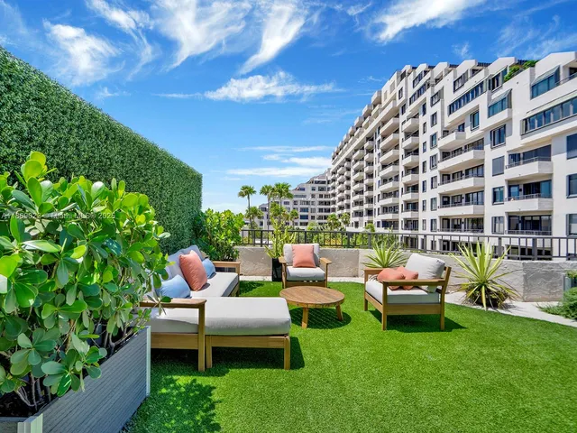 a view of a house with backyard sitting area and garden