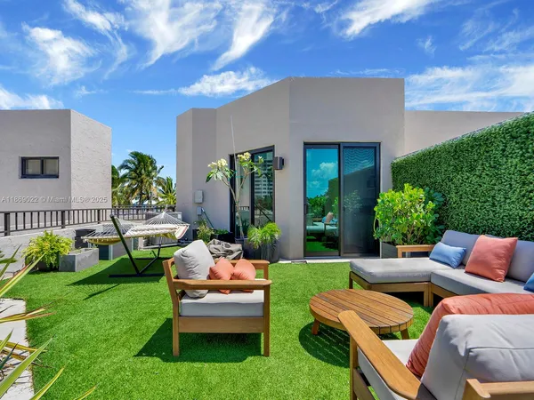 a balcony with outdoor seating and plants